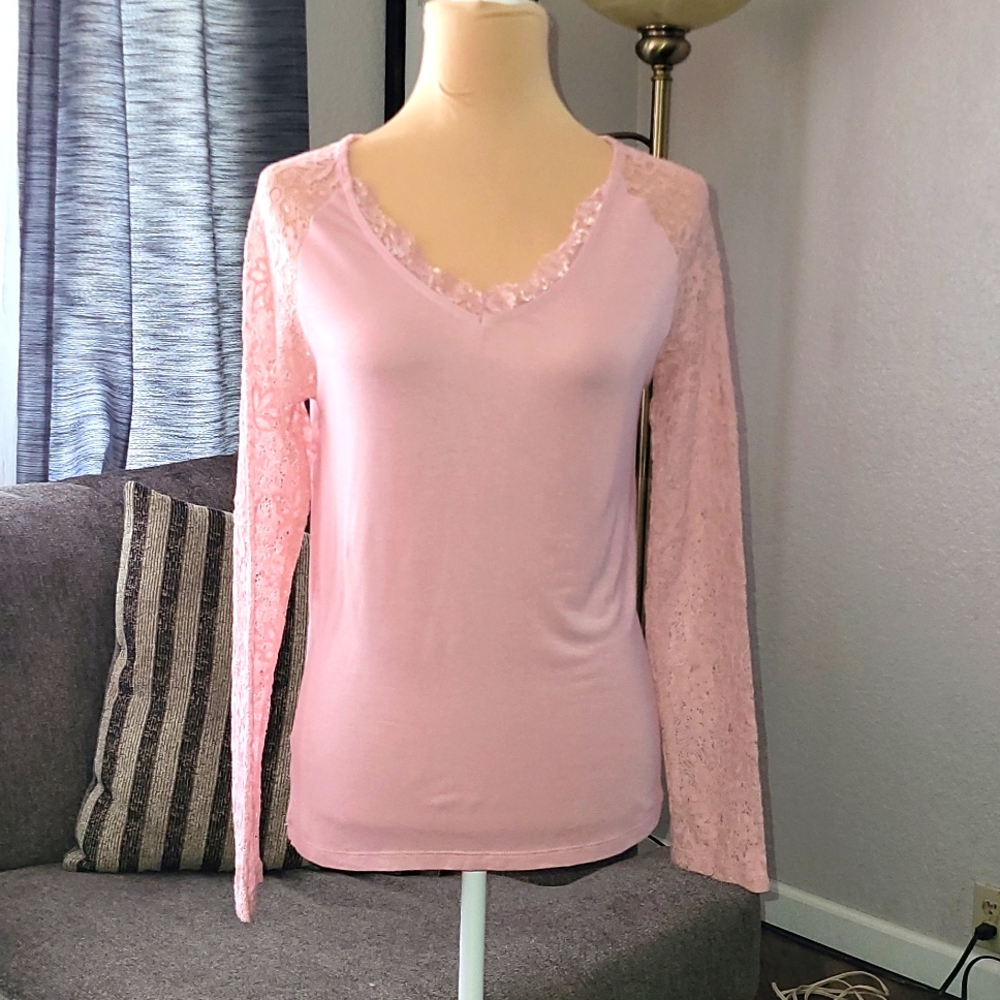 Women's pink top with lace long sleeves.